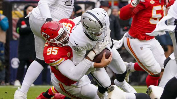 Las Vegas Raiders quarterback Aidan O'Connell (4) is sacked by Kansas City Chiefs defensive tackle Chris Jones (95) during the first half at GEHA Field at Arrowhead Stadium.